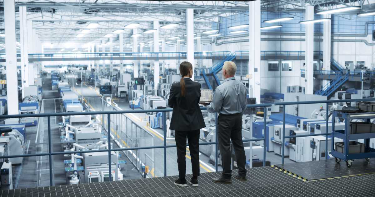 In-house manufacturing facility with man an woman overseeing processes