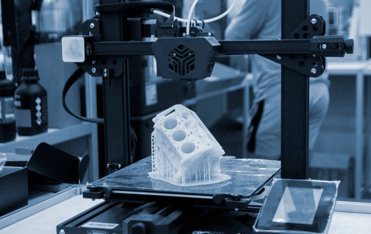 Prototype of car engine printed on 3D printer from molten white plastic