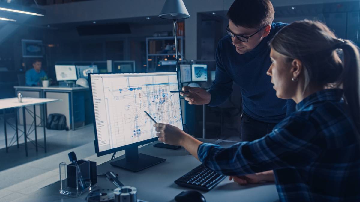 Woman uses CAD Software with Technical Blueprints