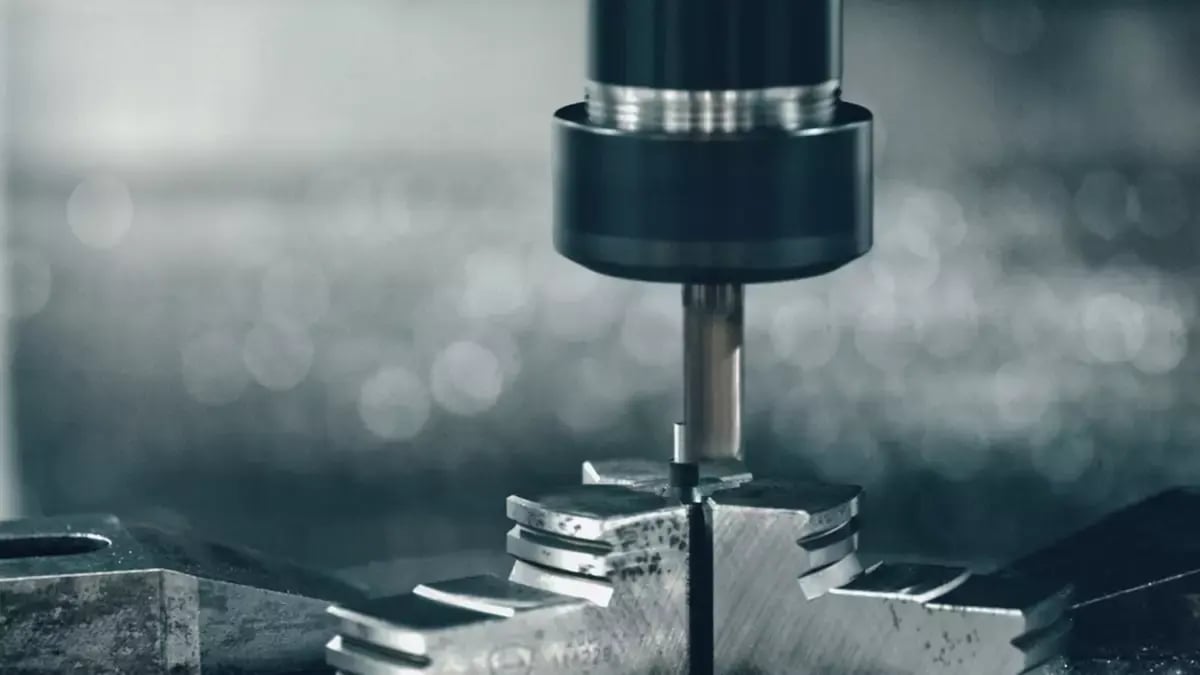 Modern CNC machine processing a metal detail in a factory