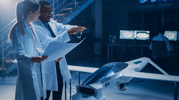 Man and woman reviewing design for new aerospace aircraft