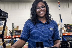 A worker smiles for the camera in our aerospace manufacturing facility. 