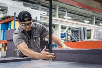 Man adjusting foam during custom foam molding process at RCO Engineering