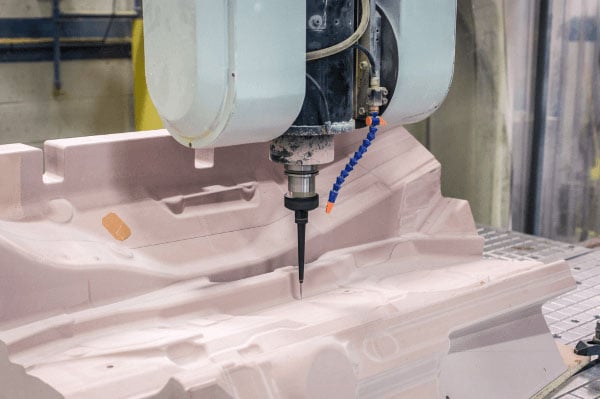 A machine working a large block of material for prototype tooling