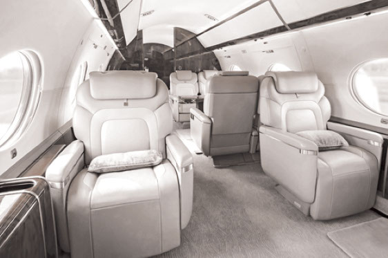 A high end business jet interior with leather appointed seats. 