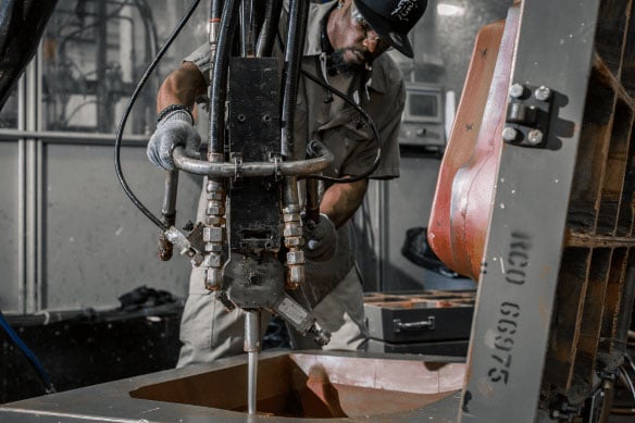 Man working on a machine working molded foam