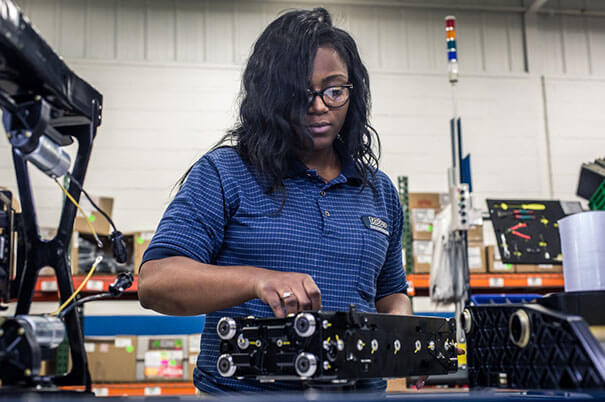 A woman assembling in low volume production services